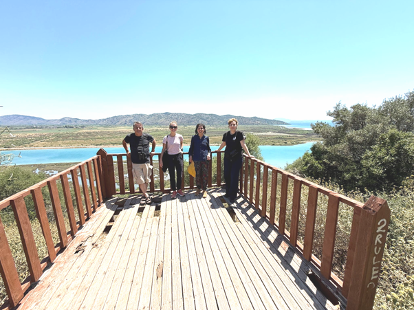 Group shot of the 4 team members on a deck overlooking the Vrina Marshes